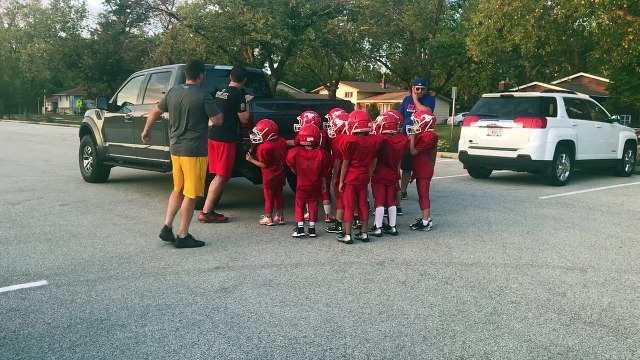 Youth Football Team Pushes Truck Around Parking Lot