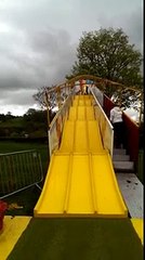 Dad comes down kids slide too fast and goes flying