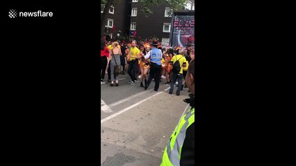 Dancing police officer takes a twirl at the Notting Hill Carnival