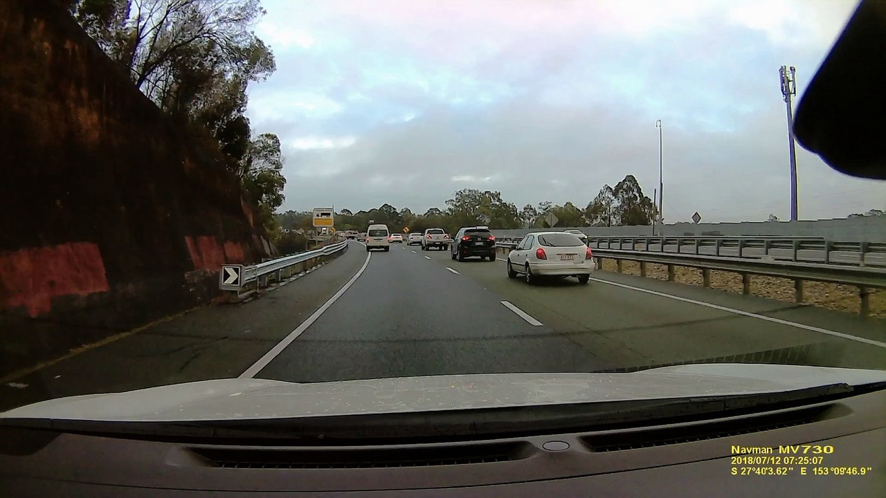 Van Nearly Collides with Road Barrier