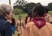 Theresa May Dances With Local Scouts During Kenya Visit