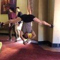 Dancer Eats Chips While Performing Splits Between Two Walls