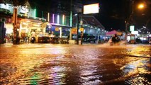 Vehicles battle through flooded roads after downpours in Thailand coastal city