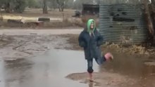 Woman Rejoices as Heavy Rains Drench Drought-Stricken Paddocks in Caroona