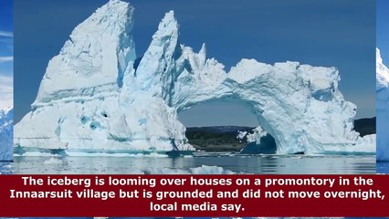 Huge iceberg  Greenland village