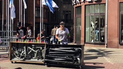 Two street artists playing on pvc pipes