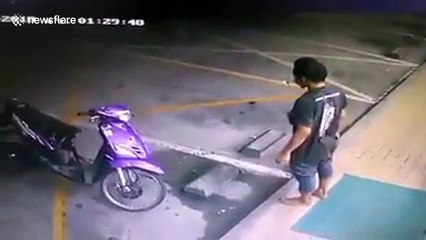 Motorcyclist takes off his shoes to enter shop... has them nabbed by driver outside