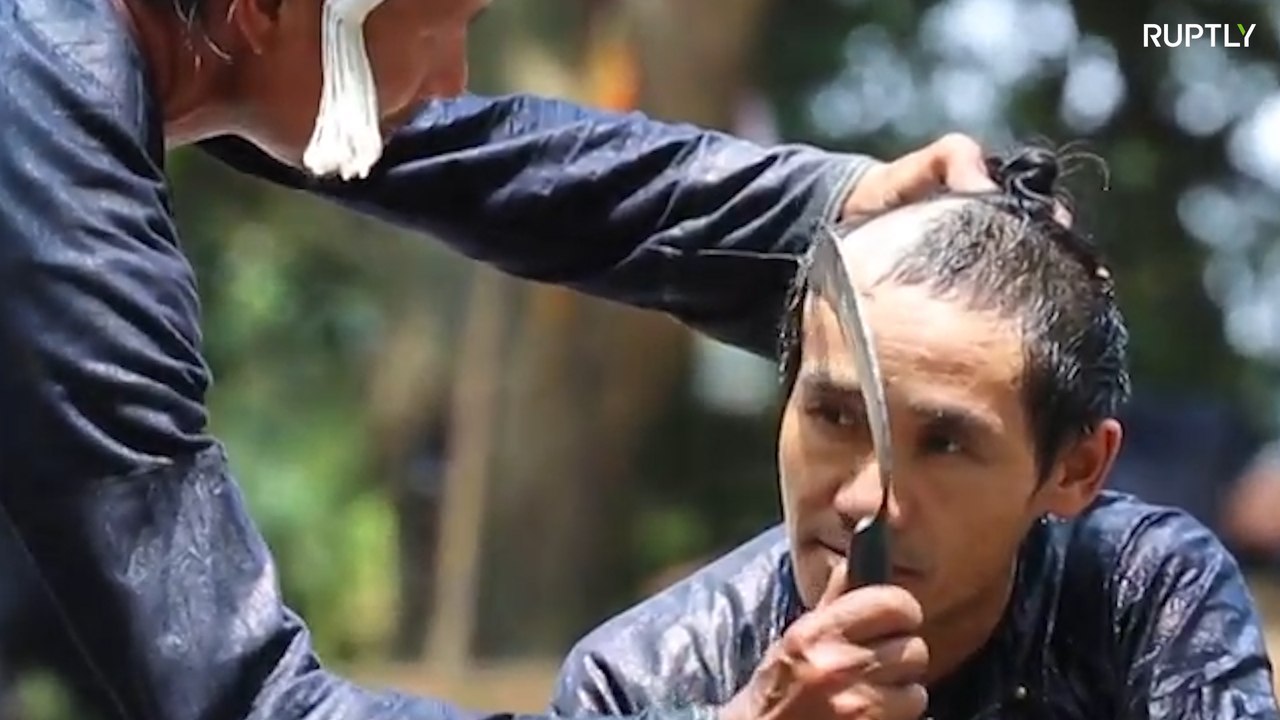 Chinese barber gives haircut with razor-sharp SICKLE