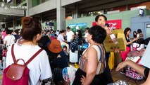 Airport personnel distribute bottled water to travelers stranded on Kansai Airport island