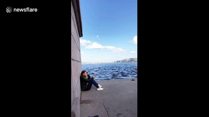 Russian rolls up wall next to girl in St. Petersburg