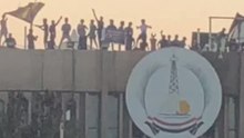 Basra Protesters Wave Flag Atop Provincial Government Office