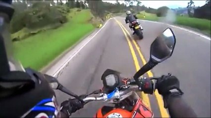 Un cycliste double deux motos en pleine descente