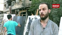 فنانون سوريون وفلسطينيون يرسمون الدمار في مخيم اليرموك