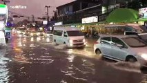 Cars drive through flooded streets of Pattaya, Thailand, as rainstorm hits