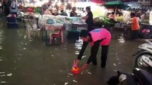 Thais Release Loy Krathong Baskets Onto Flooded Road