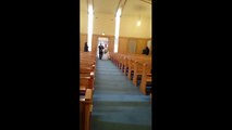 Kid dives onto bride's wedding dress while she walks down aisle