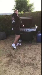 Lad throws a sausage at his mate who catches it in a bread roll