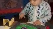 1 year old whistles as he plays with trains