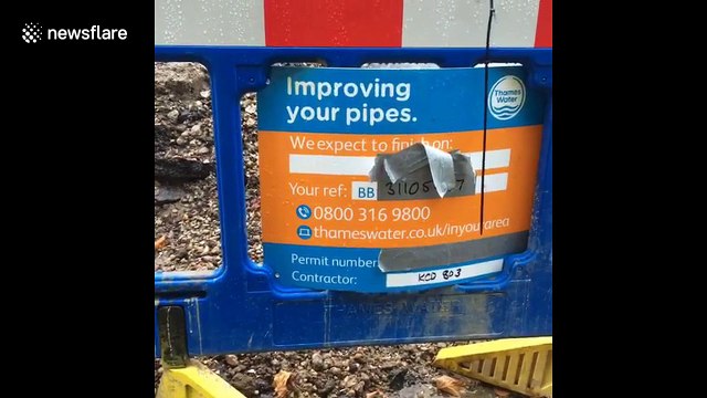 Burst water main sprays water into the air on residential London road