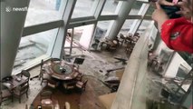 Hotel guests look on in horror as floodwaters crash into dining room