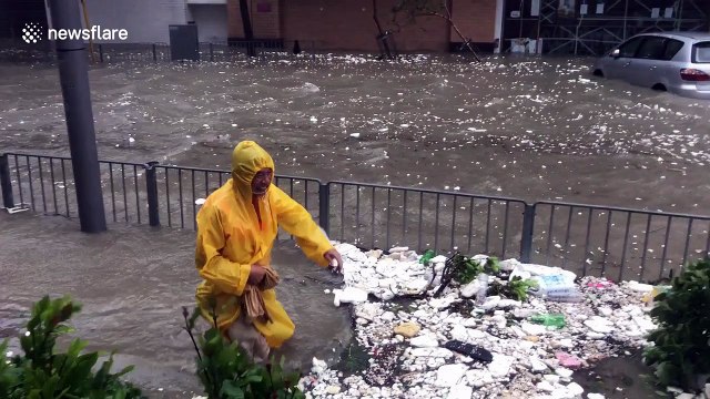 Residents tread through flooded streets as Typhoon Mangkhut brings torrential rains to Hong Kong