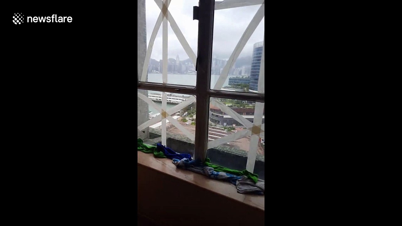 Calm after the storm: People remove duct tape from windows following Typhoon Mangkhut