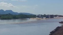 Trucks Push Through Highway Covered by Floodwaters in Sonora