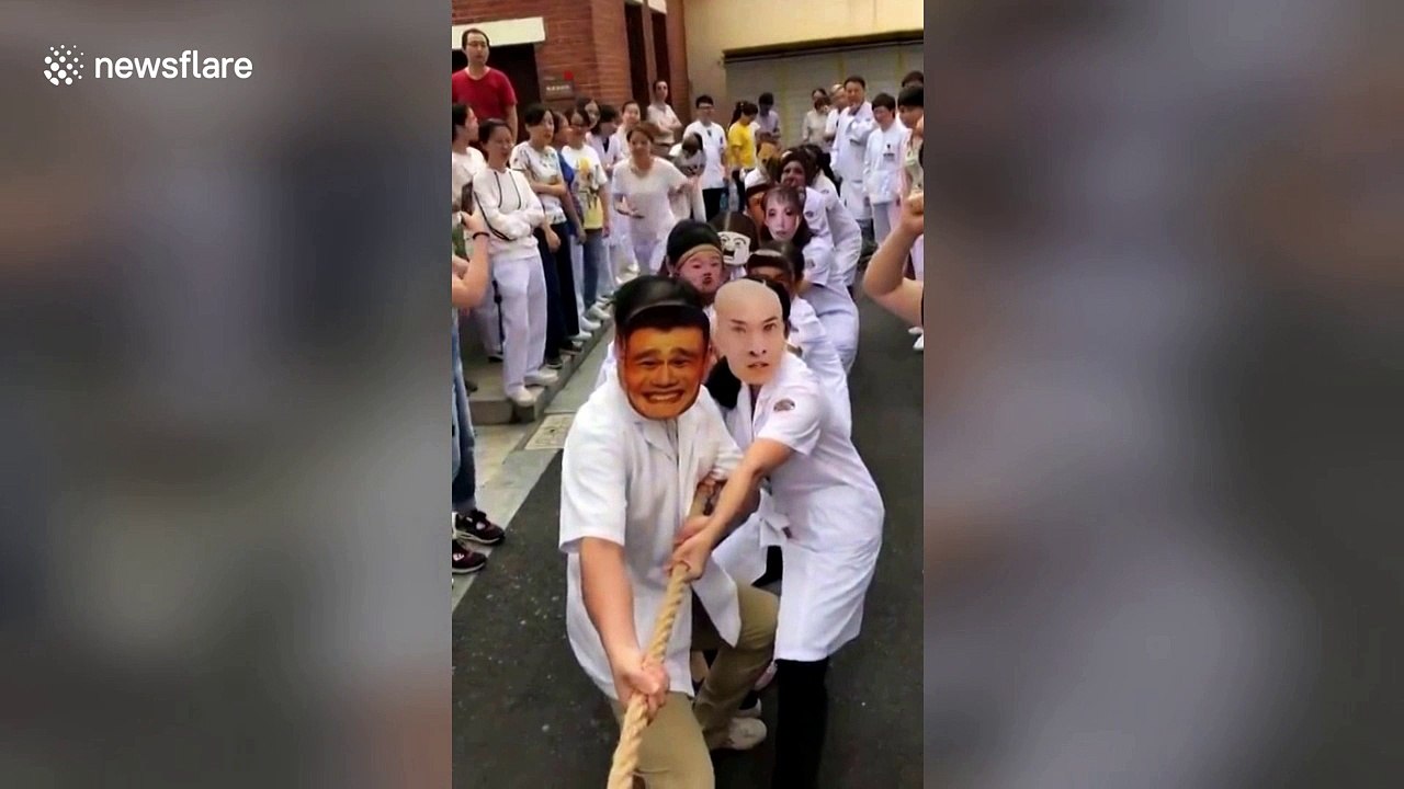 Paramedics wear funny masks during tug-of-war to disturb competitors