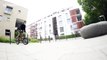 BMX biker rides down walls, over bins and benches