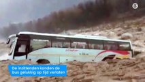 Toeristenbus meegesleurd door woeste rivier