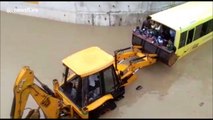 Locals rescue 35 children on bus stuck in flooded underpass