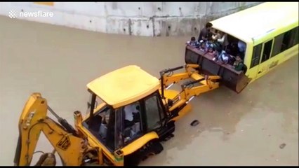 Locals rescue 35 children on bus stuck in flooded underpass