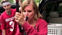 Mom at College Football Tailgate Hits Beer Bong While Her Husband Watches in Adoration
