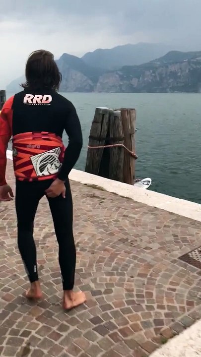 Windsurfer Tumbles into Water from Dock