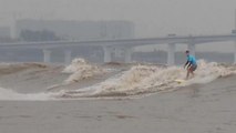 Surfers from around the world gather to ride tidal bores of the Qiantang River