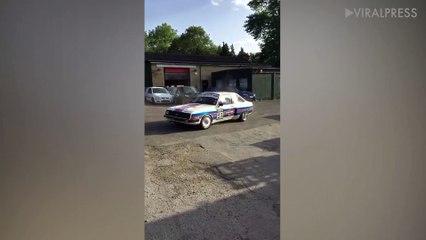 Racing Car Does Donut Outside Garage