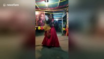 Touching moment young woman dances with teddy bear adorned with late father's face