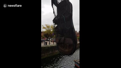 Giant sandal is suspended over Liverpool dock for festival