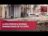 Lluvia ‘pega’ en Tultepec; derriba barda y arrastra vehículos