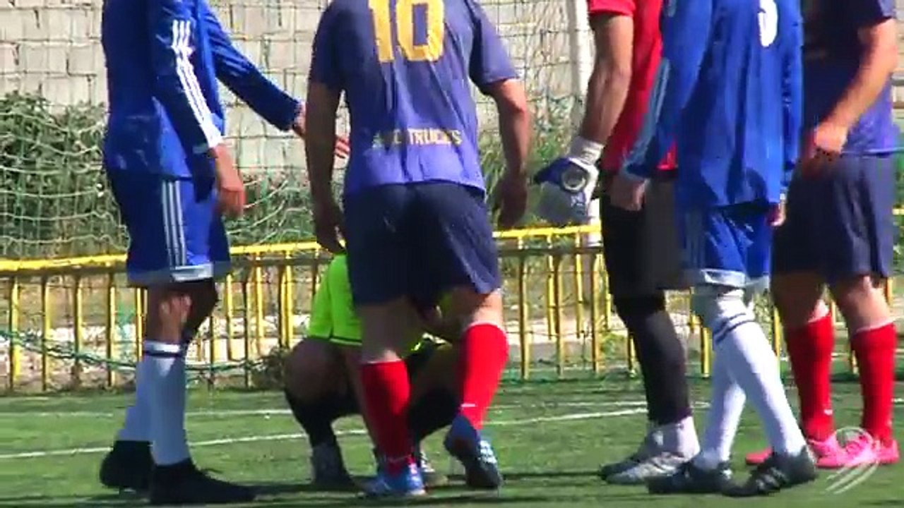 A football referee scores a penalty kicked by the goalkeeper