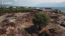 Drone footage shows large ship swept onto land by force of Palu tsunami