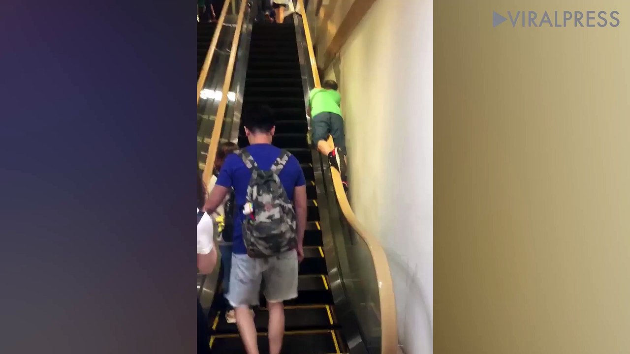 Man Straddling Escalator Handrail