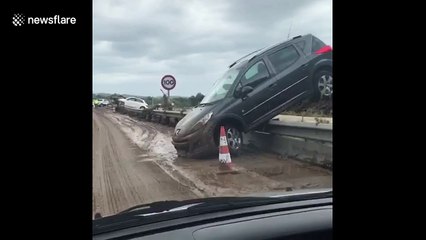 Footage shows partially upturned cars on road in aftermath of deadly Mallorca floods