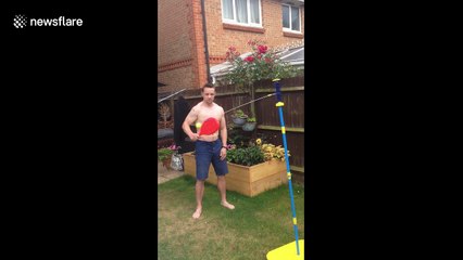 Dad get smacked in the face twice during family swingball game