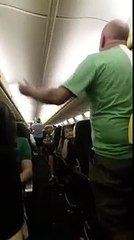 Air steward passes the microphone to travelling football supporters for a sing song