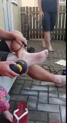 Dad Removes Dry Skin On His Feet Skin With A Power Tool