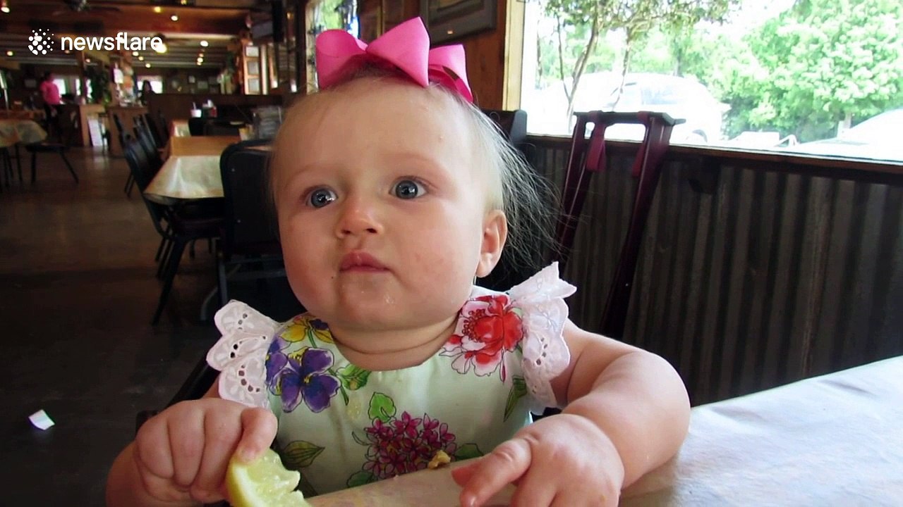 Adorable moment baby eats lemon for the first time