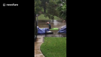 Resident kayaks through waterlogged street to rescue neighbor's boat as severe flooding hits Central Texas