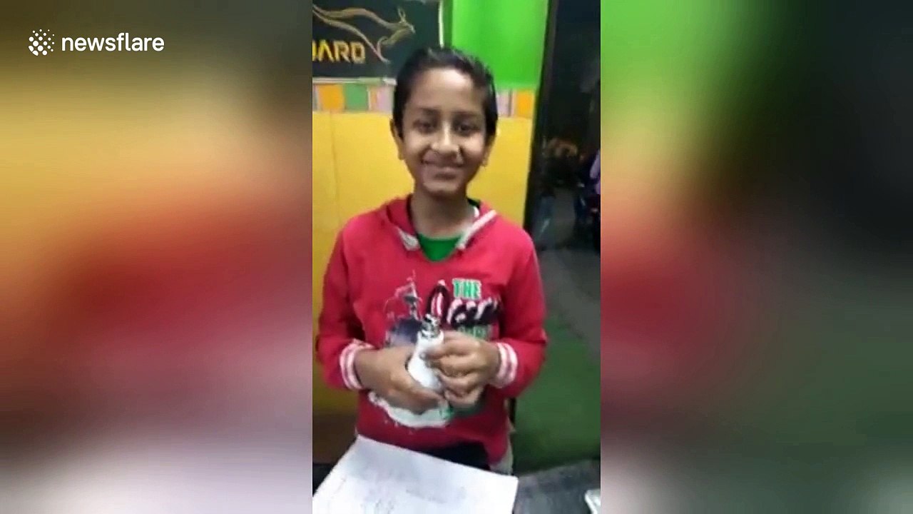 The incredible moment an Indian boy lights up a light bulb with just his bare hands