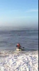 gets dumped by a wave in his kayak